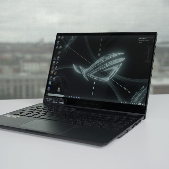 The ROG Flow X13 on a table overlooking a city.