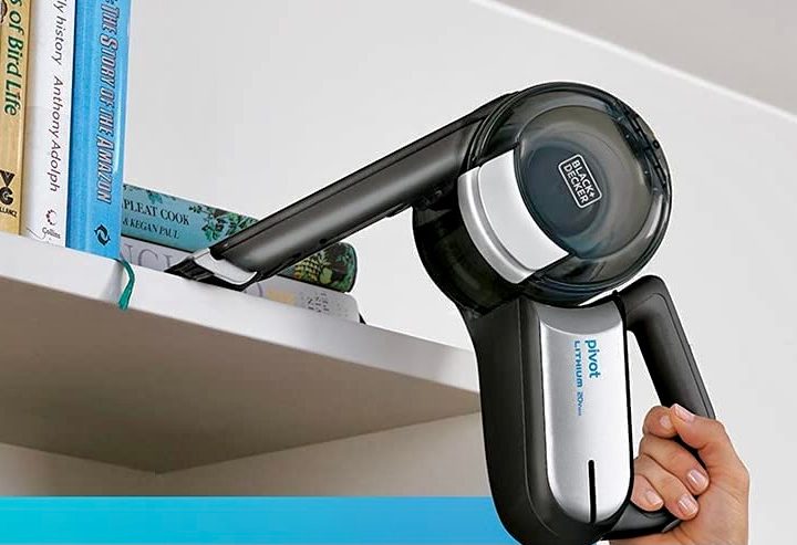 The Black + Decker Max being used to clean a shelf.