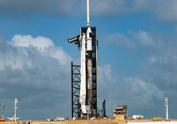 The Falcon 9 rocket from SpaceX with the Cargo Dragon spacecraft atop stands at the launch pad at NASA’s Kennedy Space Center in Florida.