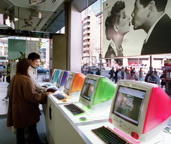 Couple using the iMac G3.