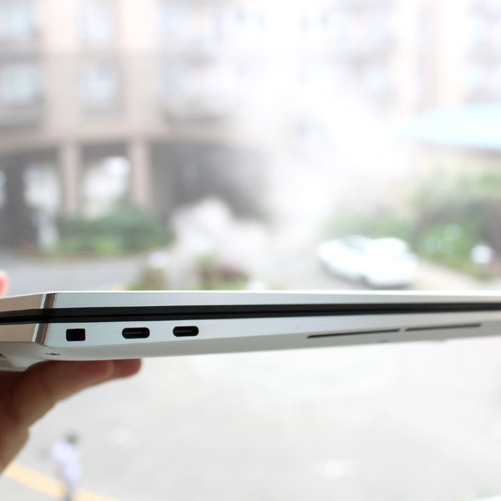 The closed Dell XPS 17, being held in a hand.