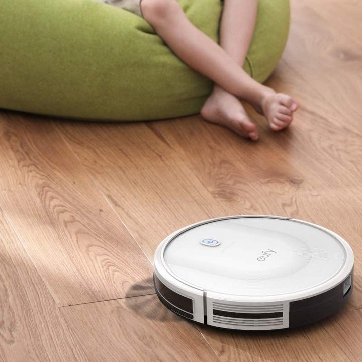 Eufy RoboVac 11S sweeping up the floor with a brush.