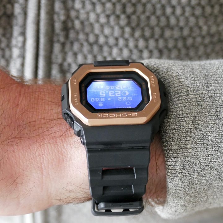 The G Shock GBX-100NS with the backlight illuminated.