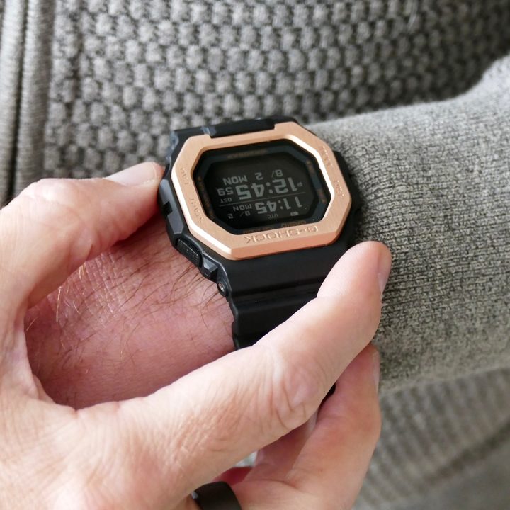 The G Shock GBX-100NS with buttons being pressed.