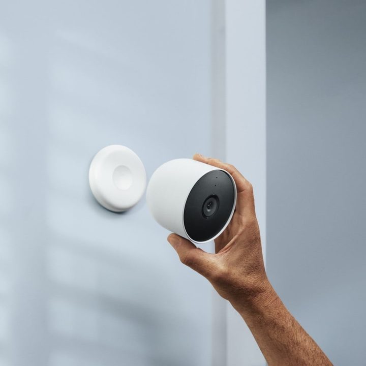 A hand adjusting the Google Nest Cam (battery).