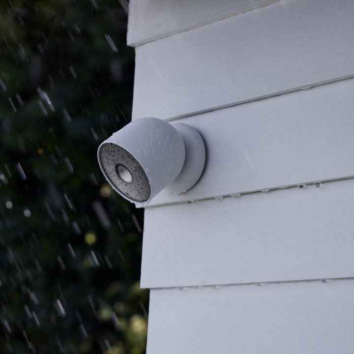Google Nest Cam (battery) mounted to the side of a home.