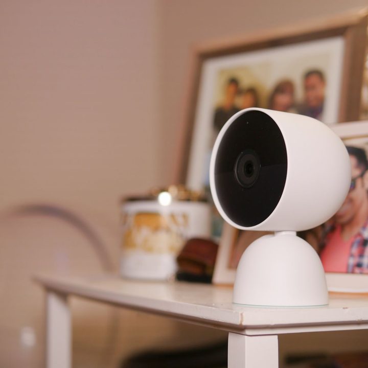 Google Nest Cam (battery) with indoor stand on table.