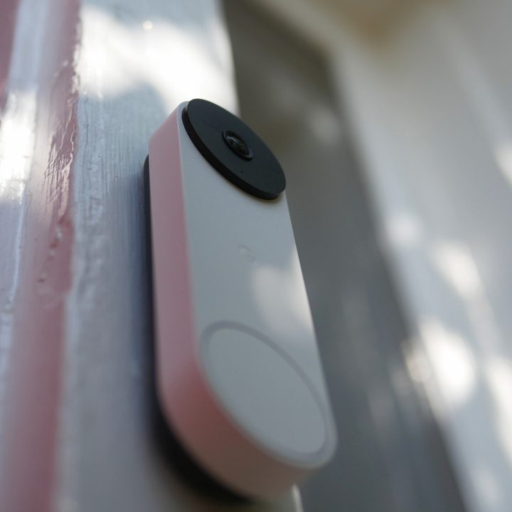 Closeup of Google Nest Doorbell (battery) on outside of door.