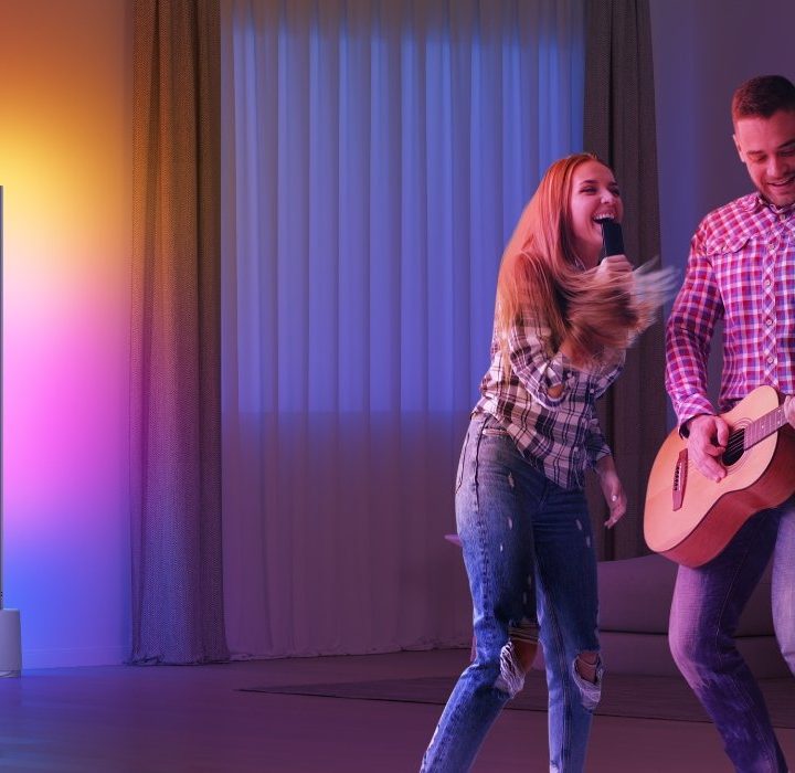 Two people singing next to Govee Lyra Lamp.