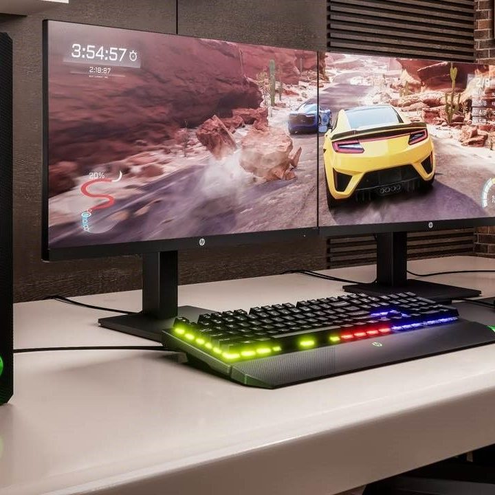 One of the HP X series monitors next to an HP desktop.