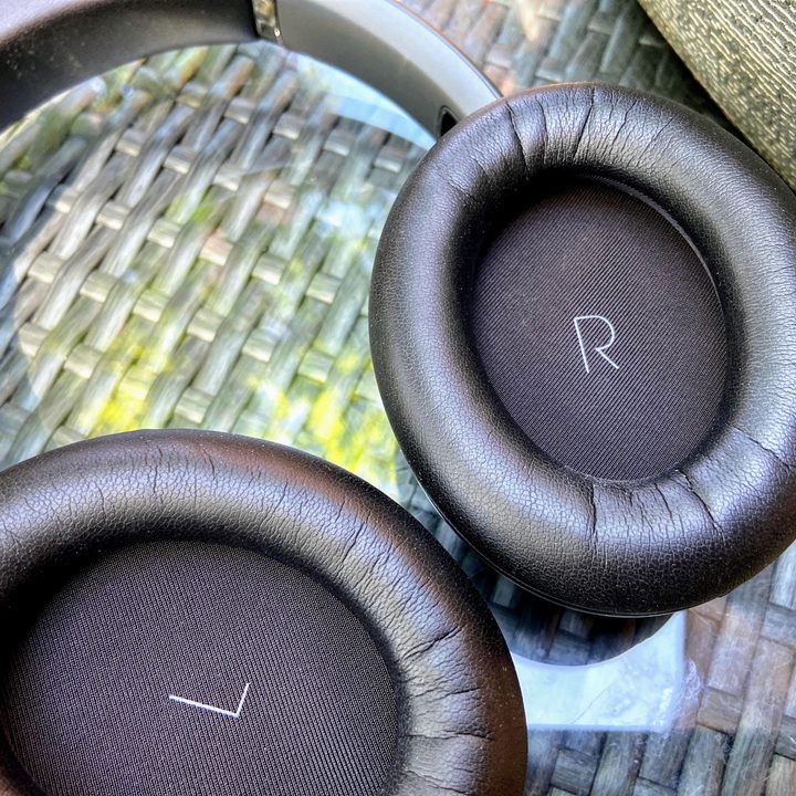 JBL Tour One wireless noise canceling headphones earcups close-up.