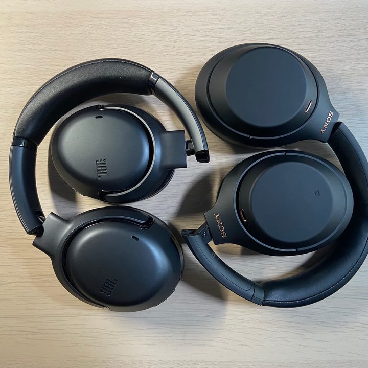 JBL Tour One wireless noise-canceling headphones beside Sony's WH-1000XM4.
