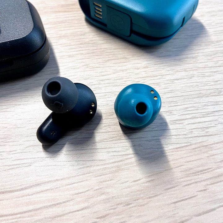 JLab Go Air Pop and Skullcandy Dime earbuds side by side.