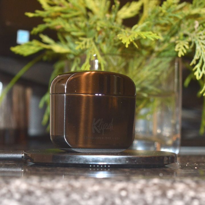 Klipsch T5 II ANC charging on a wireless charger.