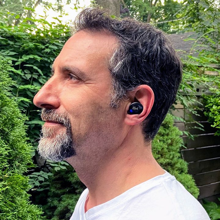 Man wearing Klipsch T5 II ANC true wireless earbuds.