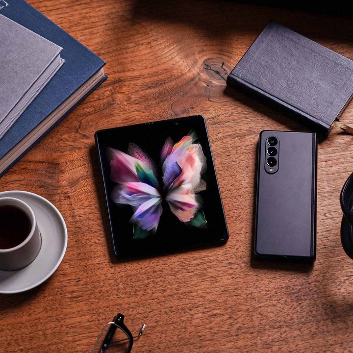 Galaxy z fold 3 5g in phantom black sitting on desk.