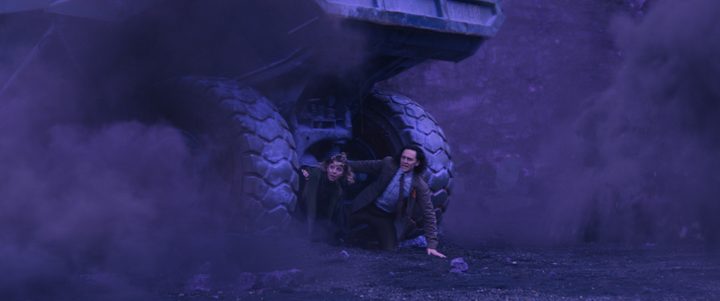 Sophia Di Martino and Tom Hiddleston hide under a mining vehicle in Marvel's Loki series.