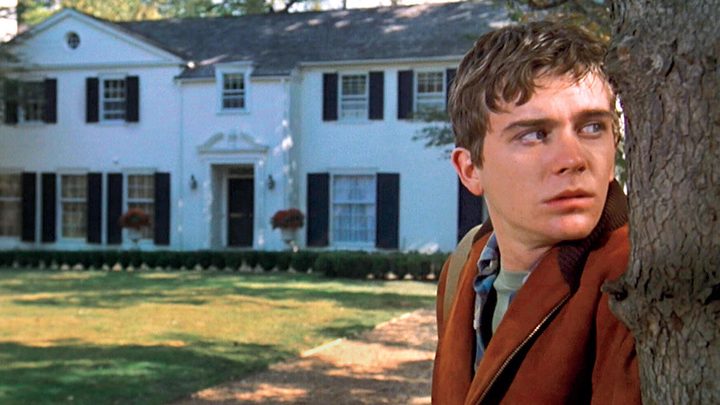 A boys stands outside his home in Ordinary People.