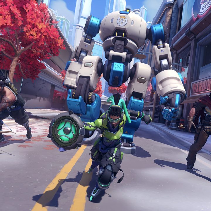 A team of Overwatch characters advance up a street in Overwatch 2.