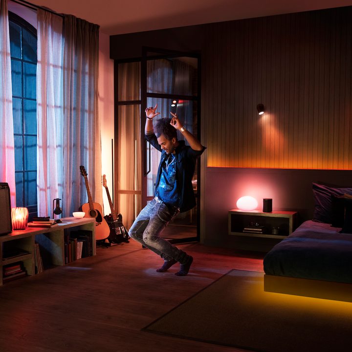 Man dancing to Philips Hue lights and Spotify song.