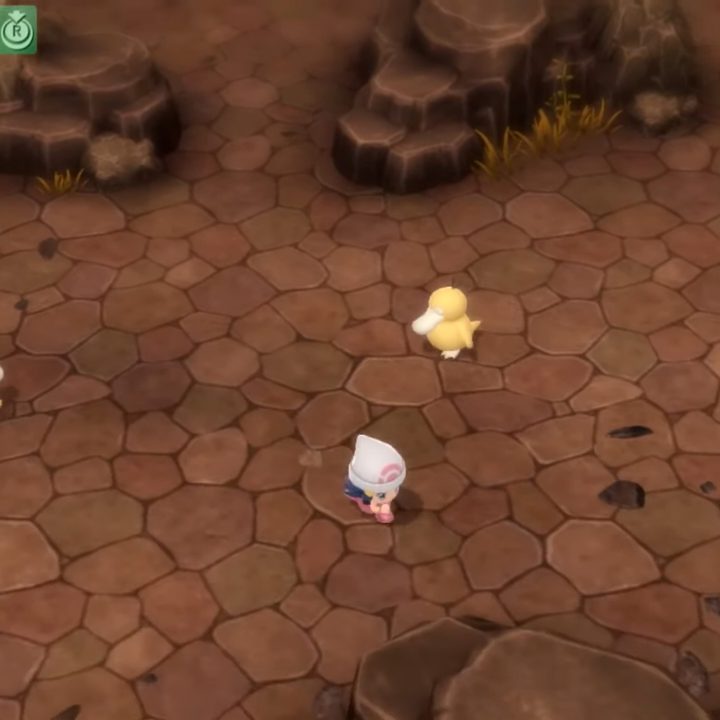 A Trainer runs across a Pokemon Hideaway in the Grand Underground.