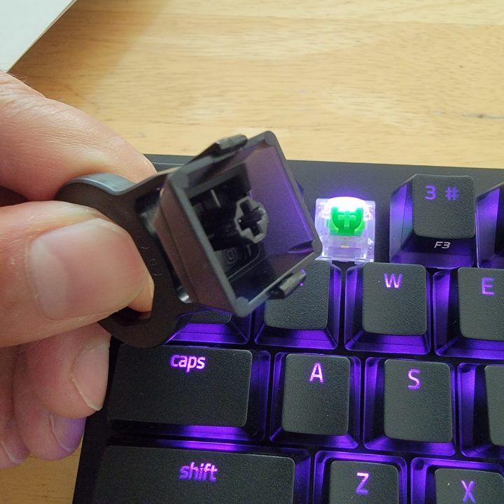 Pulling the Razer keycap off.