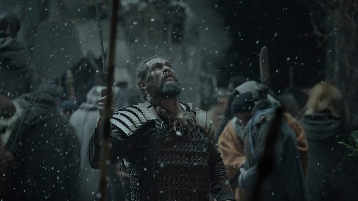 Jason Momoa looking up at snow falling from the sky in a scene from Apple TV+ See.