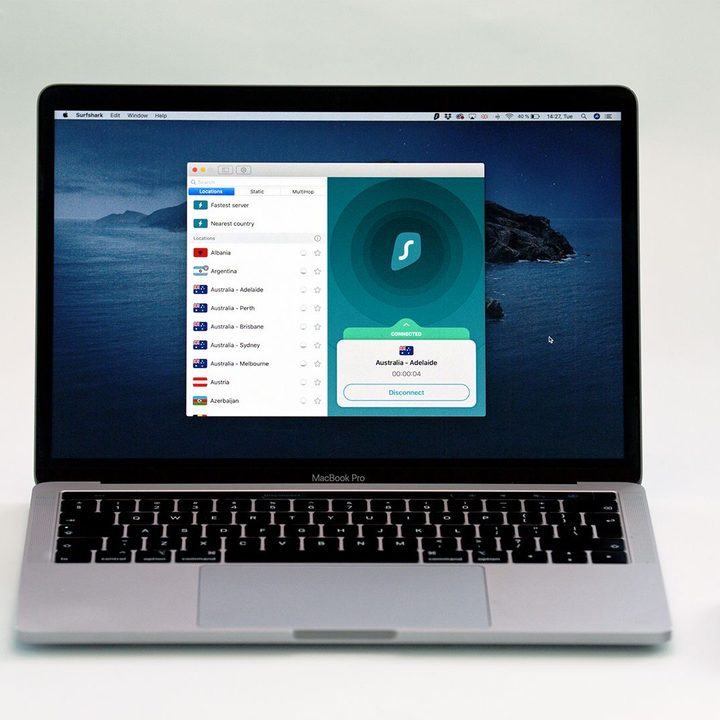 Surfshark open on a MacBook Pro against a white background.