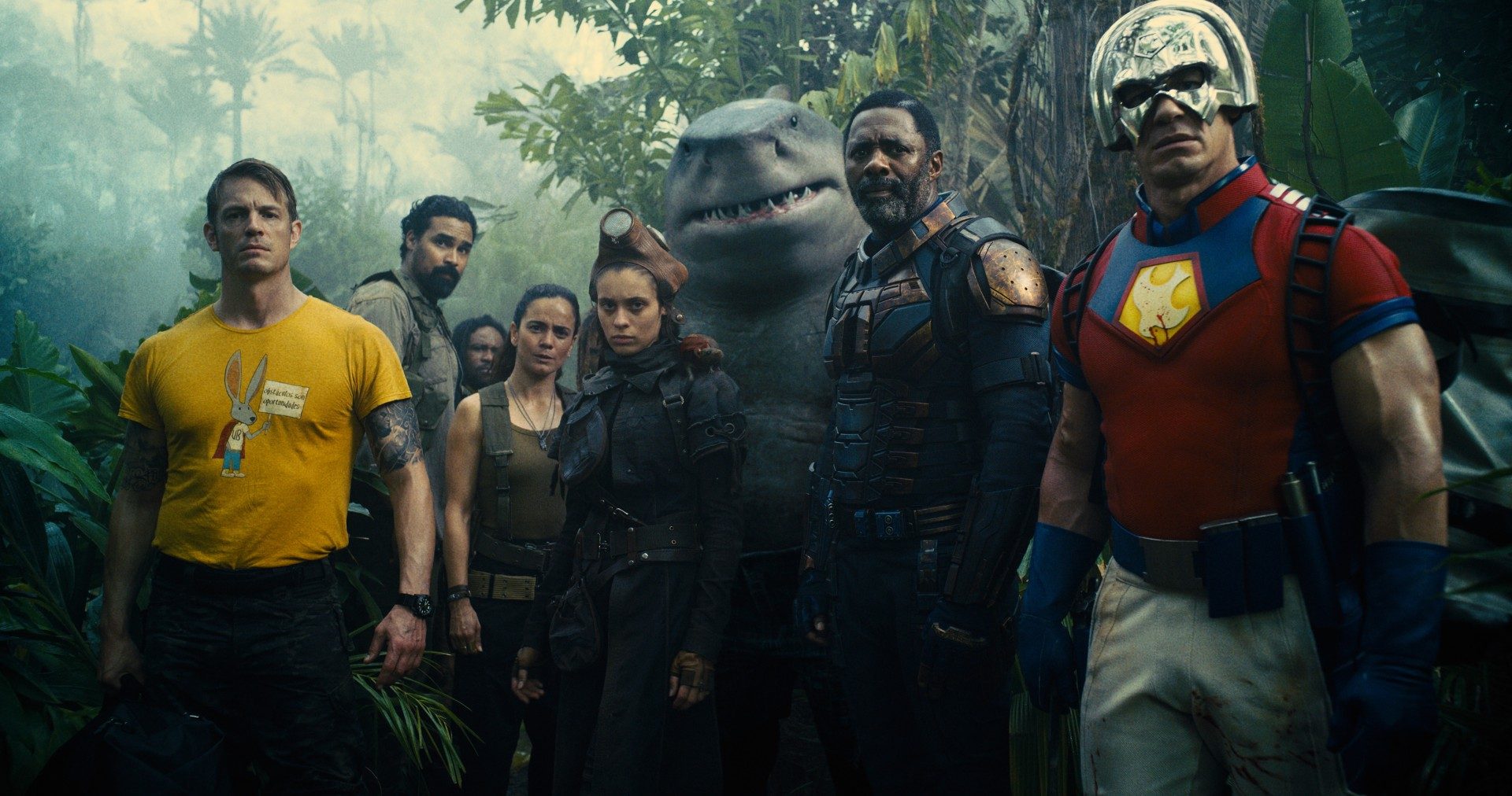 The Suicide Squad cast stands in the jungle.
