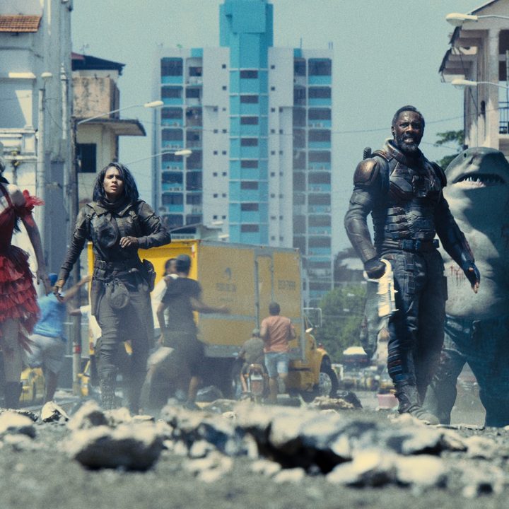 The cast of The Suicide Squad standing in rubble.