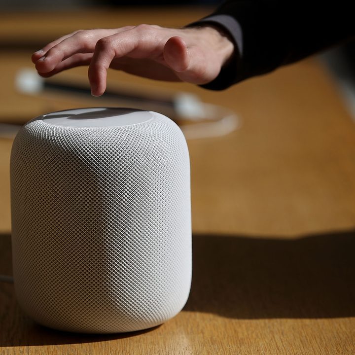 Customers inspect the new Apple HomePod at an Apple Store on February 9, 2018 in San Francisco, California.