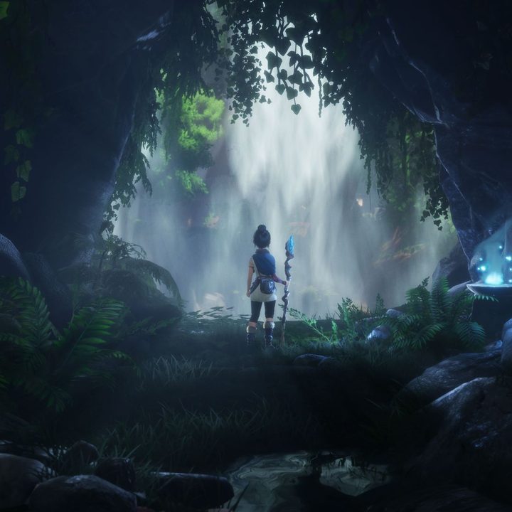 Kena stands in front of a waterfall in Kena: Bridge of Spirits.
