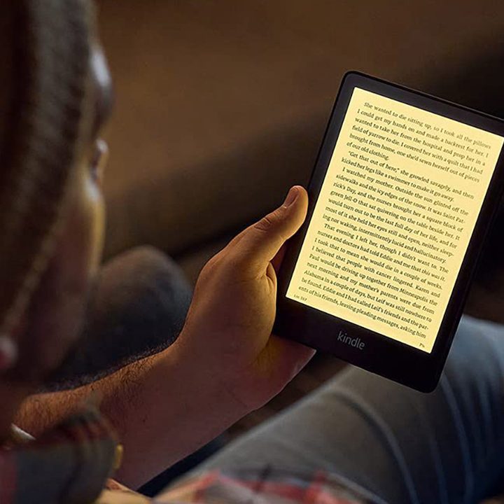 Person reading an Amazon Kindle Paperwhite.