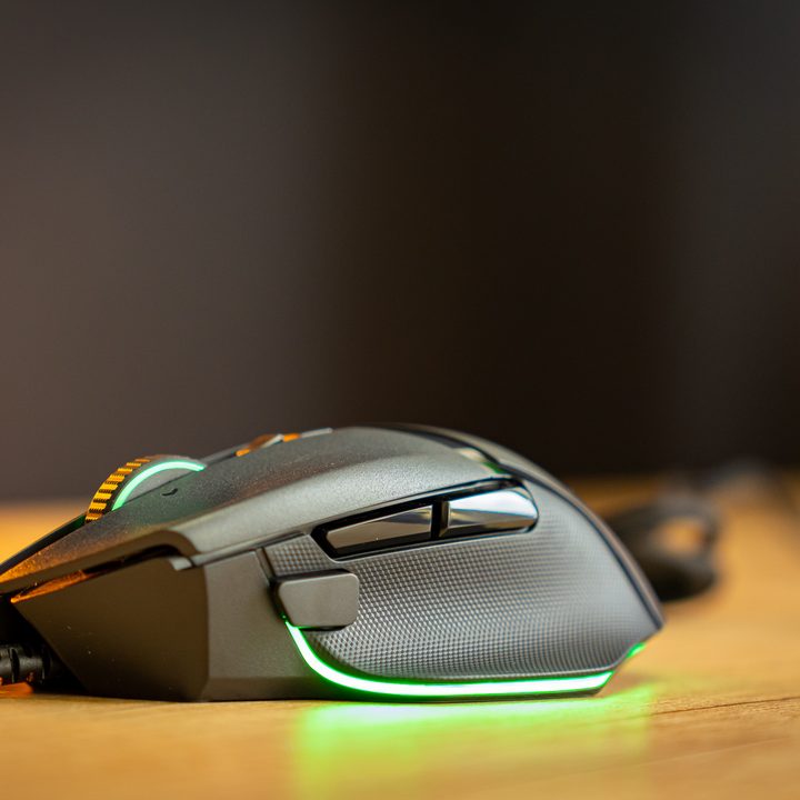 A front view of the Razer Basilisk V3, showing the side buttons and RGB.