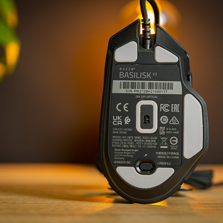 A bottom view of the Razer Basilisk V3, showing the sensor and slippy pads.