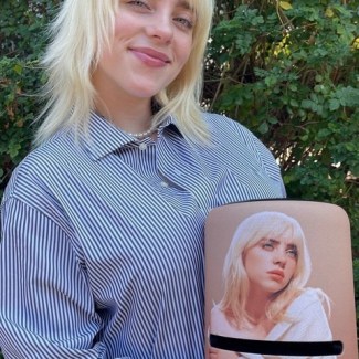 Billie Eilish posing with Amazon Echo Studio Billie Eilish Special Edition speaker.