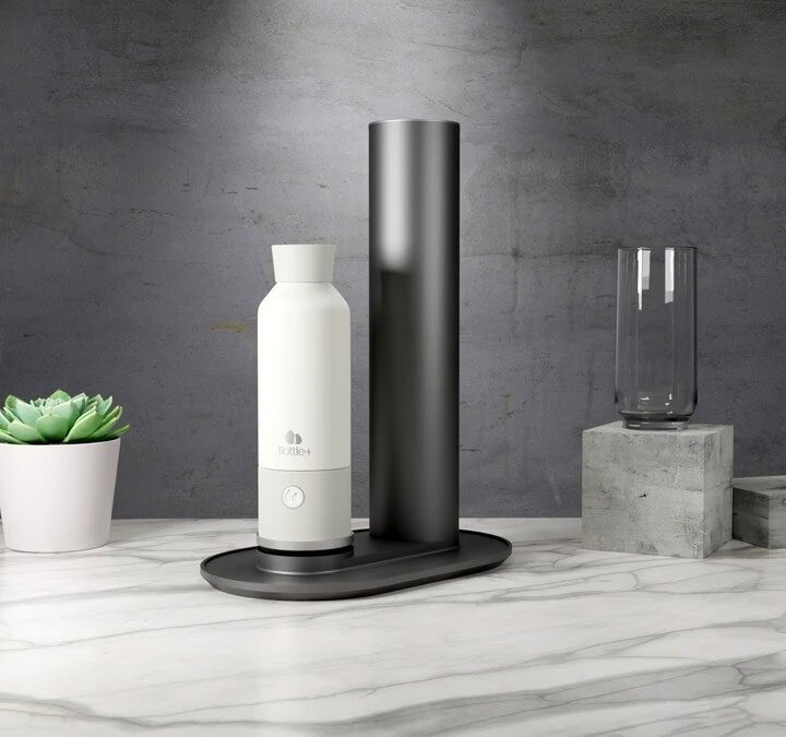 Bottle+ mounted on docking station on marble counter.