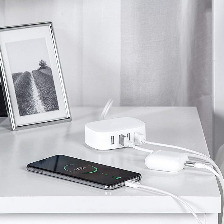 The Bull USB charging station on a bedside table. A smartphone is charging by the side of it.