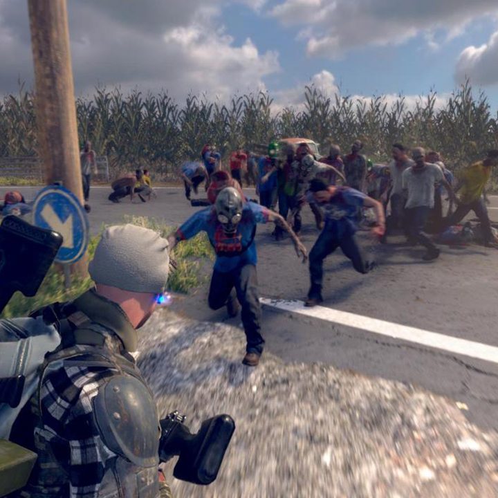 A lone man stands with his gun raised as he is attacked my zombies