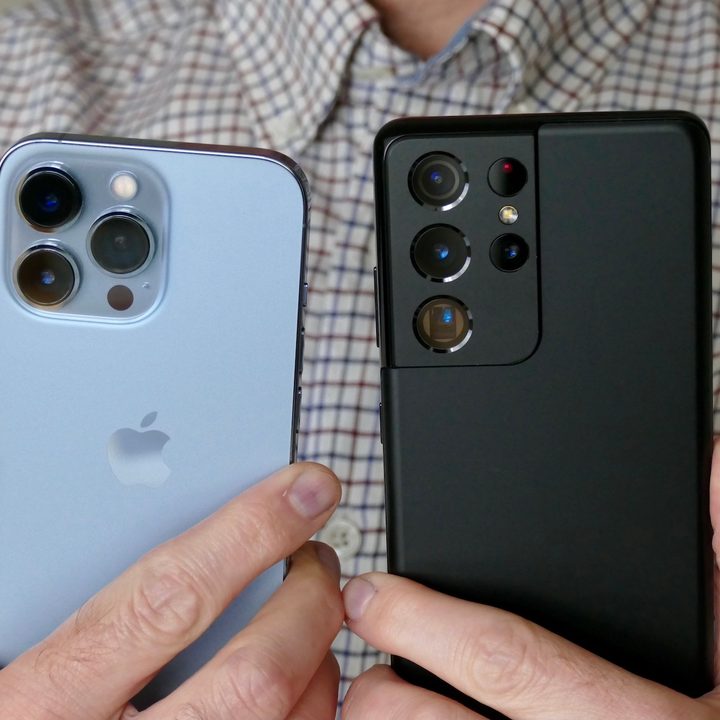 The iPhone 13 Pro and Galaxy S21 Ultra held in hand.