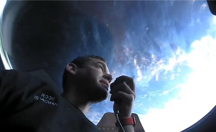 Jared Isaacman looking out out of the Crew Dragon's cupola.