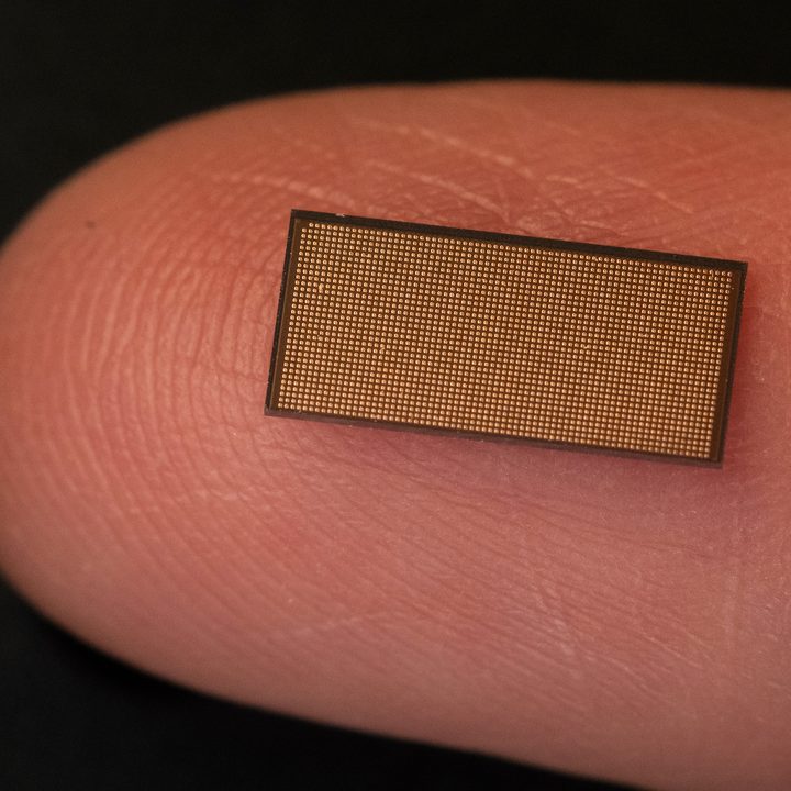 Intel's Loihi 2 neuromorphic chip on a fingertip.