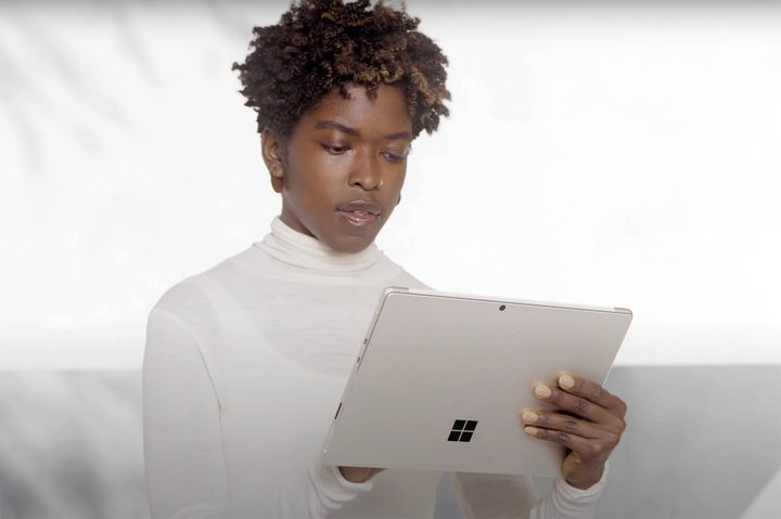 Woman using the Microsoft Surface Pro 8 in tablet mode.