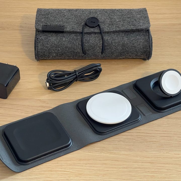 The Mophie 3-in-1 Travel Charger with MagSafe, shown with travel case and power adapter on a table.