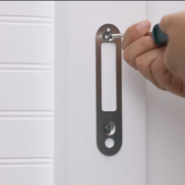 Nest Doorbell screwing in the base plate.