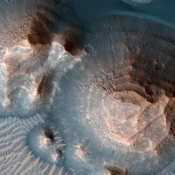 This image shows several craters in Arabia Terra that are filled with layered rock, often exposed in rounded mounds. The bright layers are roughly the same thickness, giving a stair-step appearance.