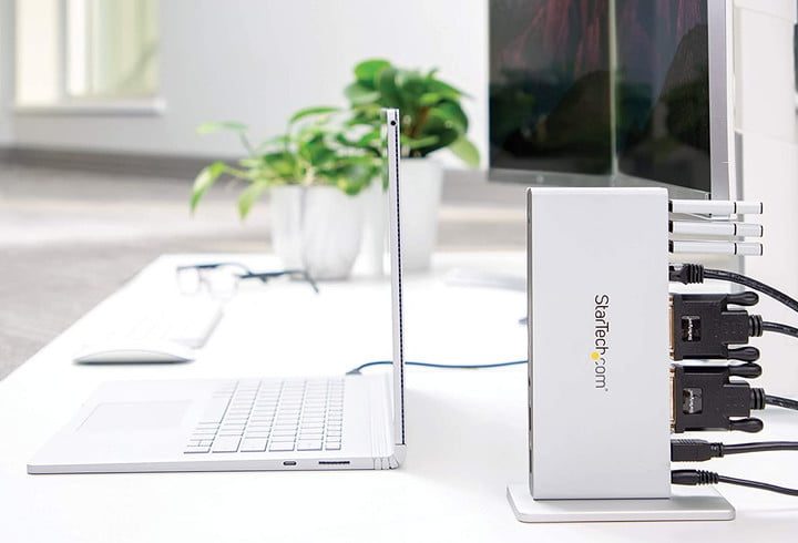 The StarTech Dual Monitor Docking Station on a desk connected a laptop and two monitors.