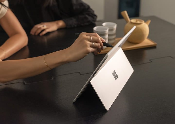 Woman using the Surface Slim Pen on the Surface Pro X.