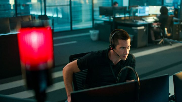 Jake Gyllenhaal sits at a desk in The Guilty.