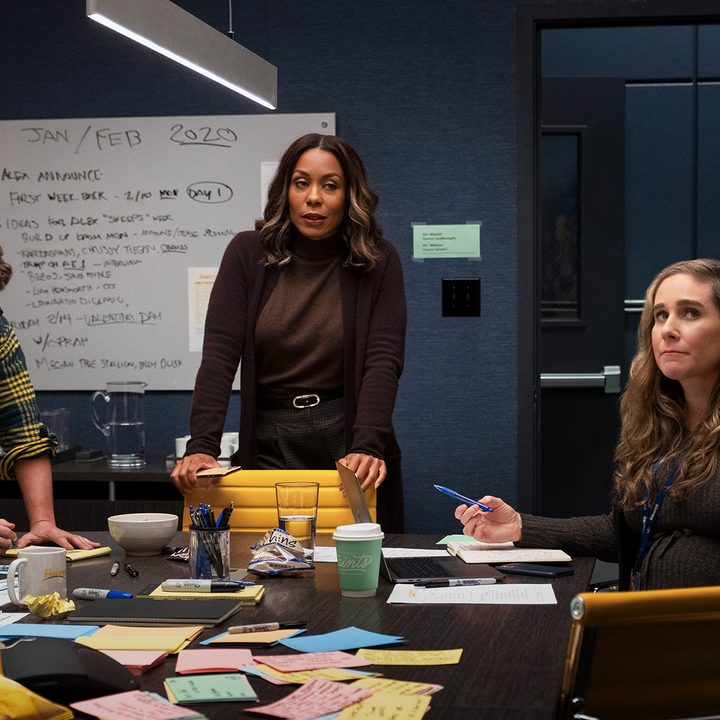 Mia in the newsroom with others in a scene from season 2 of The Morning Show.
